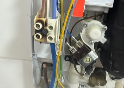 Burnt terminal block found inside an electric shower by West Plumbing in Wigan